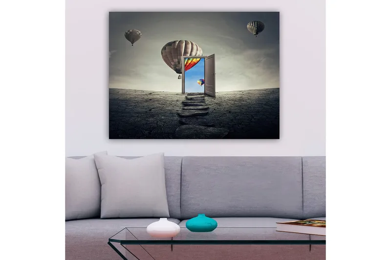 Canvastavla 70x100 cm - Öppen dörr som leder till en färgglad himmel med varmluftsballonger som svävar över en karg landskap, Grå / Beige / Röd