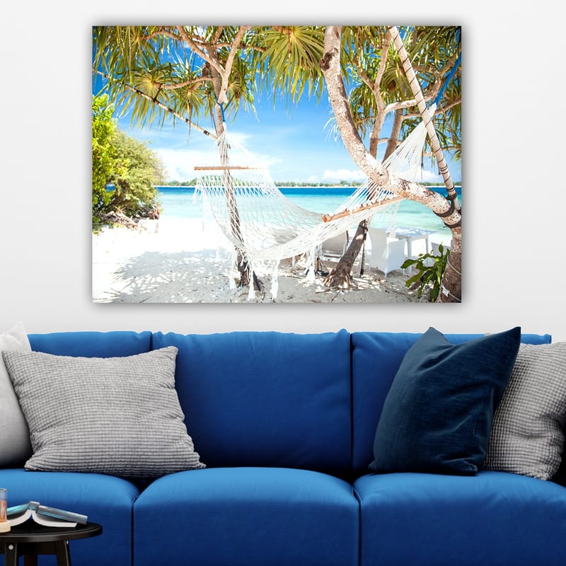 Canvastavla 70x100 cm - Avkopplande hängmatta mellan palmer vid en strand med turkost vatten och klarblå himmel - Vit / Blå / Grön - Inredning - Tavlor & konst - Canvastavlor