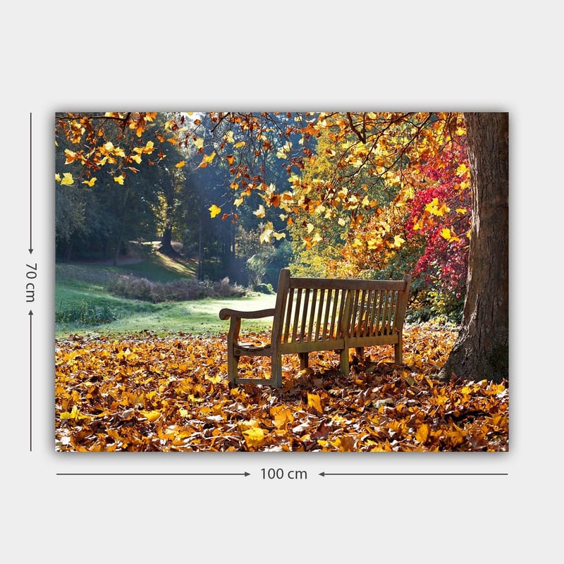 Canvastavla 70x100 cm - Bänk omgiven av färgglada höstlöv i en naturskön miljö - Orange / Gul / Röd - Inredning - Tavlor & konst - Canvastavlor