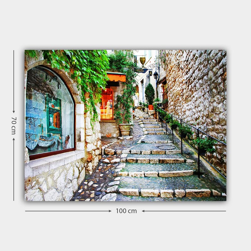 Canvastavla 70x100 cm - Charmig gränd med stenar och grönska som leder uppåt, omgiven av historiska byggnader - Grön / Beige / Orange - Inredning - Tavlor & konst - Canvastavlor