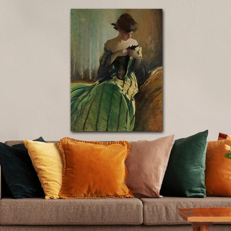 Canvastavla 70x100 cm - Kvinna i en grön klänning sitter och arbetar med något i händerna, djupt försjunken i sina tankar - Grön / Svart / Beige - Inredning - Tavlor & konst - Canvastavlor