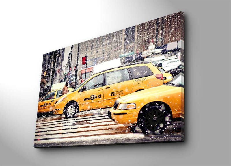 Canvastavla 70x100 cm - Livlig stadsbild med gula taxibilar som kör genom snöfall i New York City - Gul / Svart - Inredning - Tavlor & konst - Canvastavlor