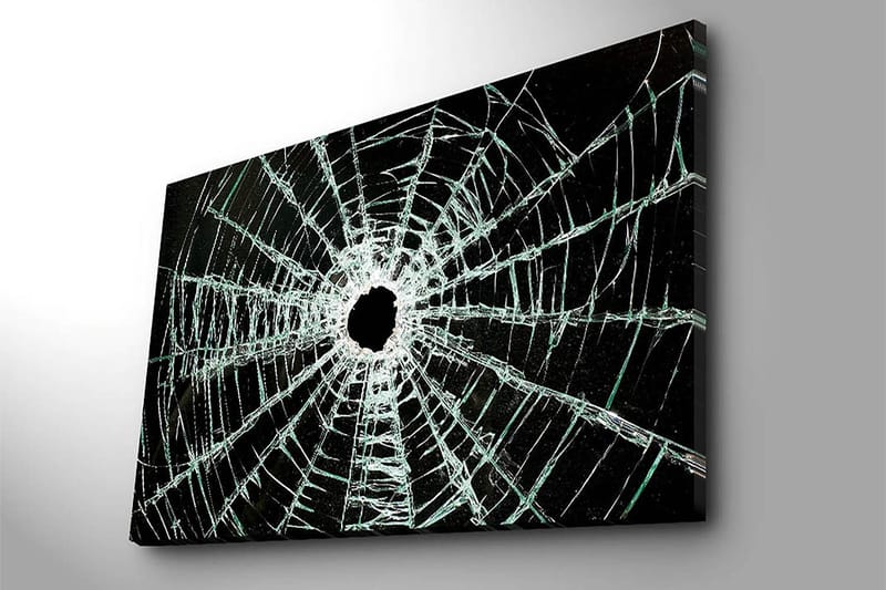 Canvastavla 70x100 cm - Närbild av en sprucken glasruta med ett centralt hål och sprickor som sträcker sig utåt - Svart / Genomskinlig - Inredning - Tavlor & konst - Canvastavlor