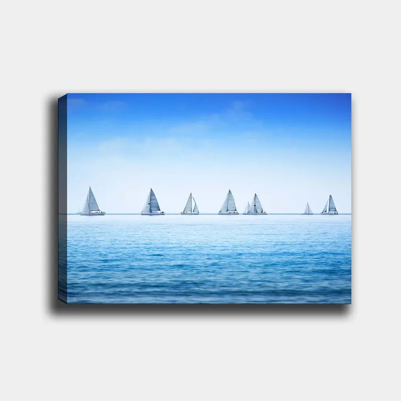 Canvastavla 70x100 cm - Segelbåtar som glider fram över en lugn sjö under en klar blå himmel, Blå / Vit