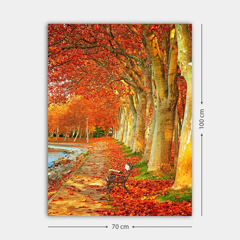 Canvastavla 70x100 cm - Vacker höstscen med en bänk längs en allé av träd med sprakande röda och orange löv - Röd / Orange / Gul - Inredning - Tavlor & konst - Canvastavlor