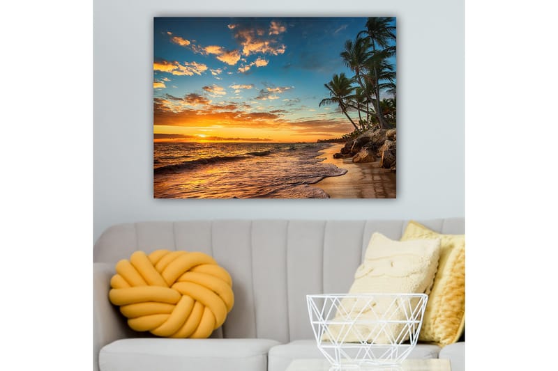 Canvastavla 70x100 cm - Vacker solnedgång vid en strand med palmer och mjuka vågor som rullar in mot sanden, Orange / Blå / Beige