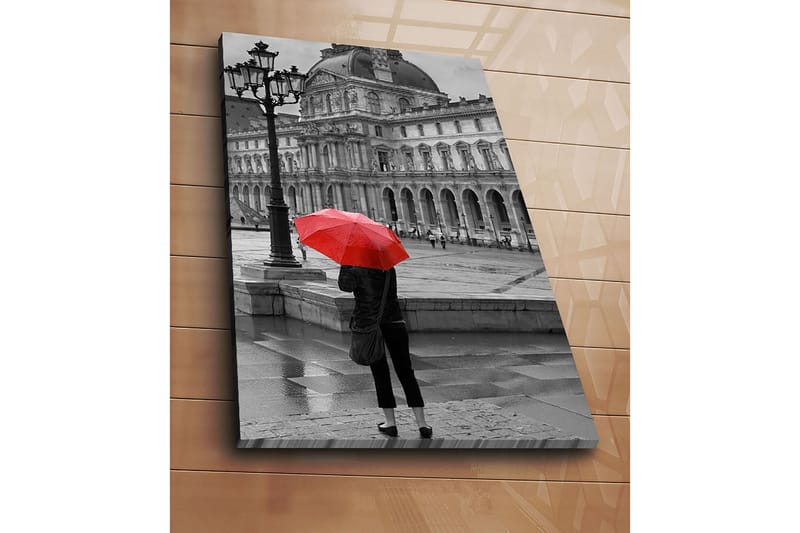 Canvastavla 70x100 cm - Person står med ett rött paraply i en regnig stadsmiljö framför en historisk byggnad - Röd / Svart - Inredning - Tavlor & konst - Canvastavlor
