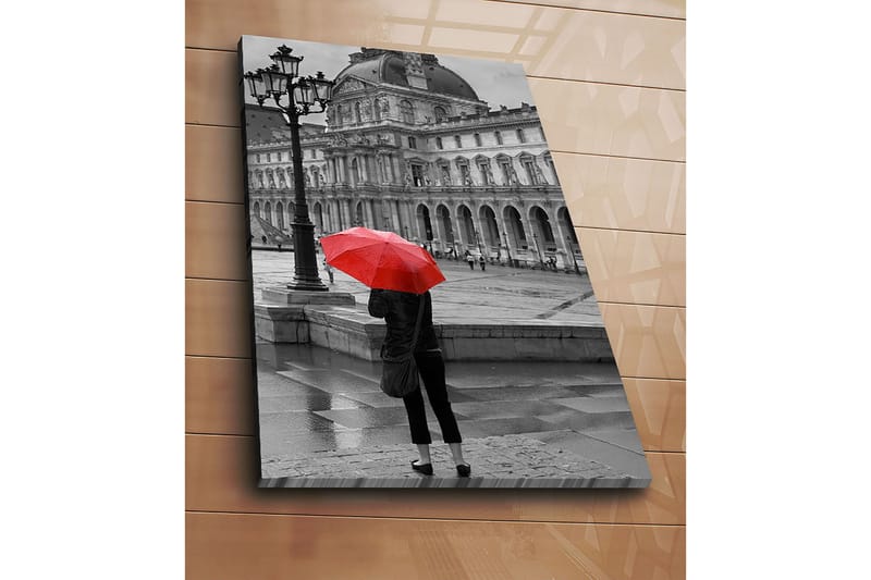 Canvastavla 70x100 cm - Person står med ett rött paraply i en regnig stadsmiljö framför en historisk byggnad - Röd / Svart - Inredning - Tavlor & konst - Canvastavlor