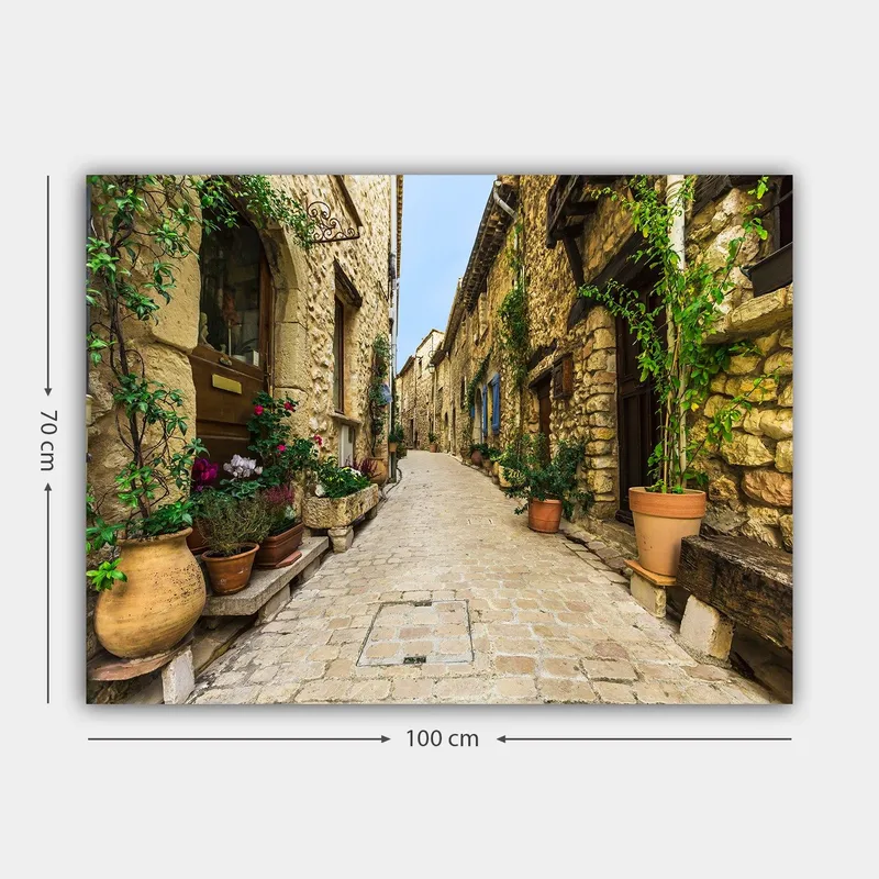 Canvastavla 70x100 cm - Pittoresk gränd i en gammal by med stenhus och blomkrukor - Beige / Grön / Terrakotta - Inredning - Tavlor & konst - Canvastavlor