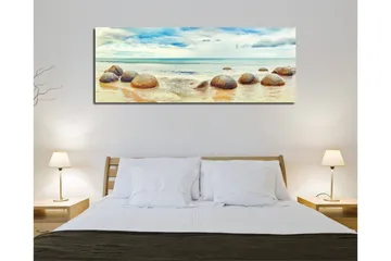 Canvastavla 80x30 cm - Runda stenar vid en strand med hav och himmel i bakgrunden - Blå / Beige / Grå - Inredning - Tavlor & konst - Canvastavlor