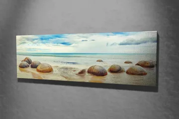 Canvastavla 80x30 cm - Runda stenar vid en strand med hav och himmel i bakgrunden - Blå / Beige / Grå - Inredning - Tavlor & konst - Canvastavlor