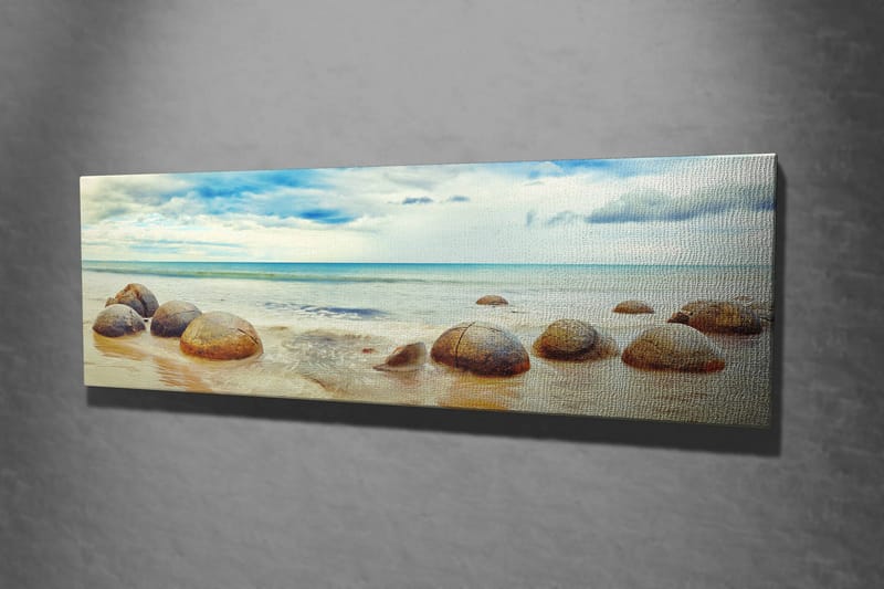 Canvastavla 80x30 cm - Runda stenar vid en strand med hav och himmel i bakgrunden - Blå / Beige / Grå - Inredning - Tavlor & konst - Canvastavlor