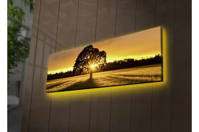 Canvastavla med LED-belysning 30x90 cm - Silhuett av ett träd mot en gyllene solnedgång, Guld / Svart / Grön
