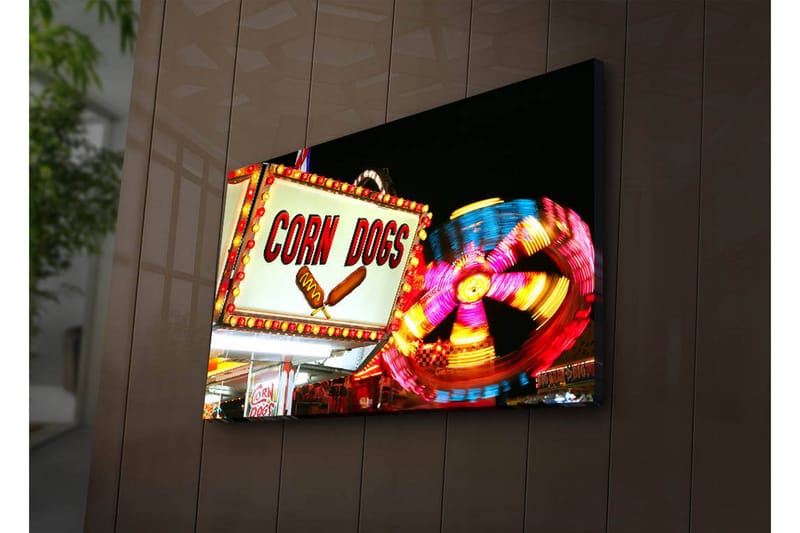 Canvastavla med LED-belysning 45x70 cm - Ljus och färgglad skylt med texten CORN DOGS och en snurrande karusell i bakgrunden, Röd / Gul / Blå